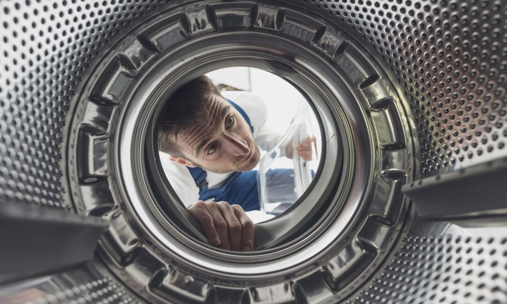 repairman-checking-the-washing-machine.jpg