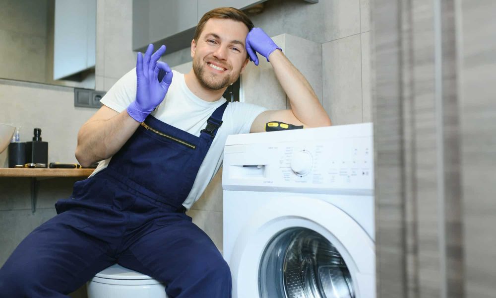 working-man-plumber-repairs-a-washing-machine.jpg